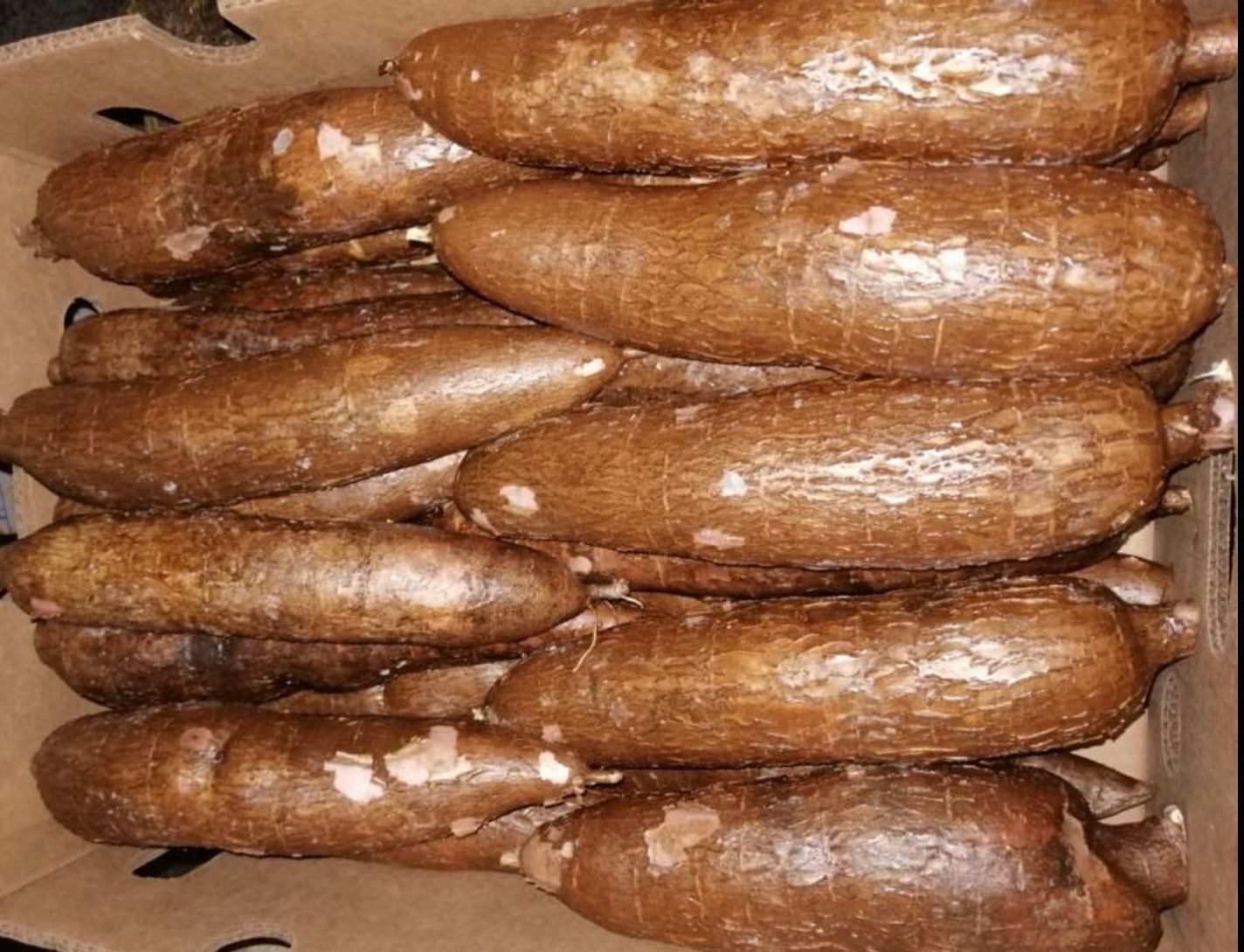 A pile of brown potatoes sitting on top of a table.